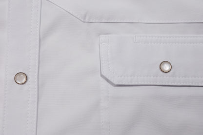 Close-up of a pearl snap pocket on a white shirt